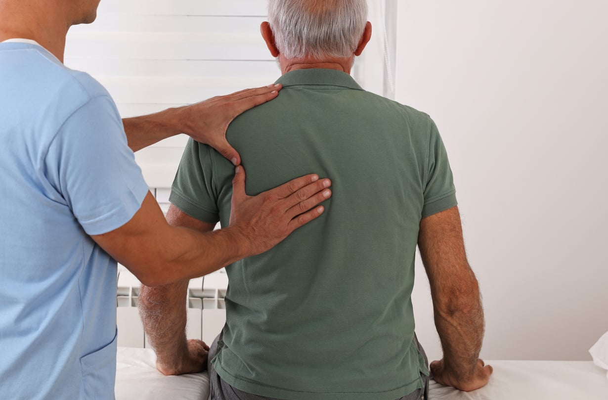 Chiropractic / Osteopathy treatment, Back pain relief. Physiotherapy for senior male patient, Kinesiology